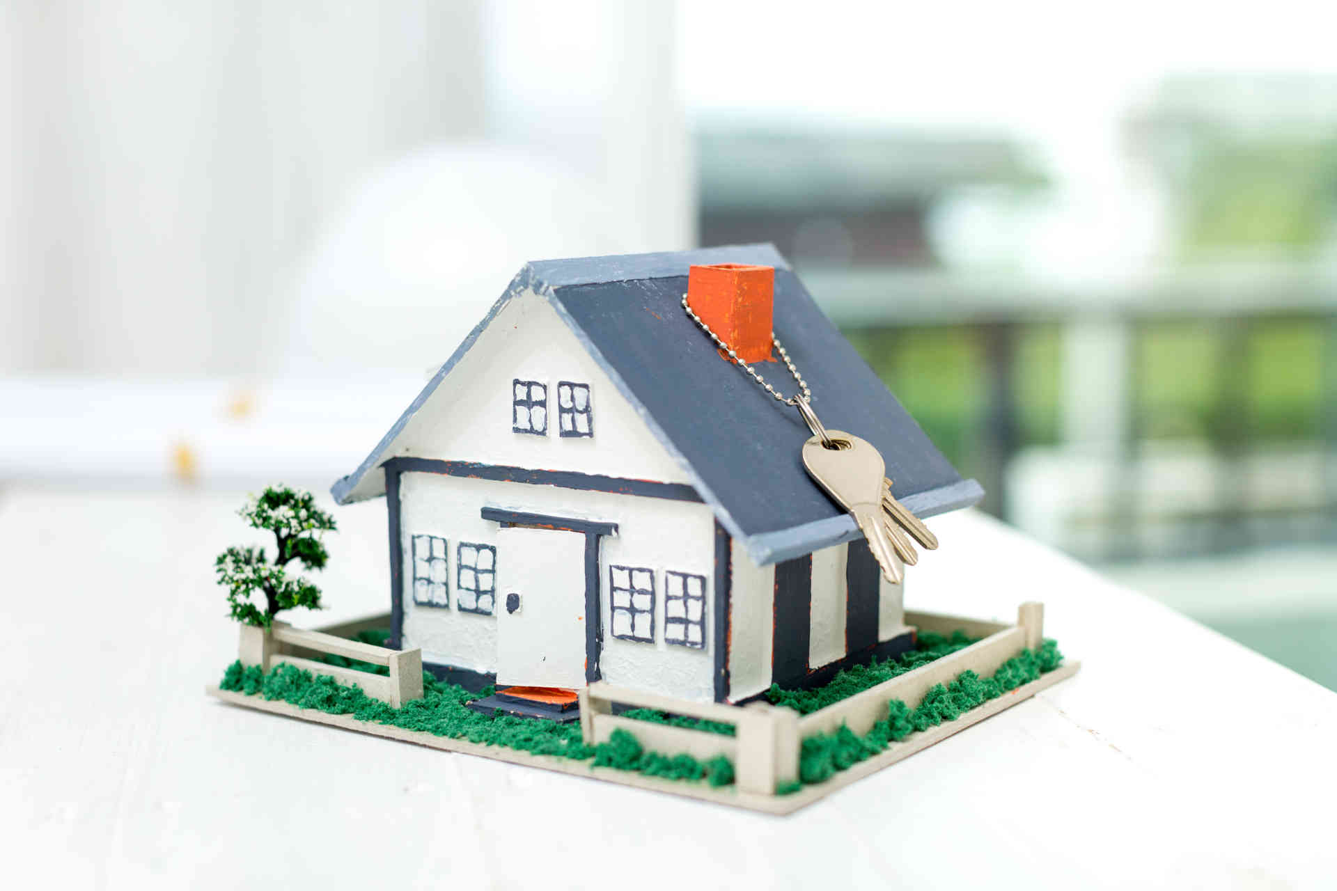 Real estate agent with house model and keys Real estate agent with house model and keys